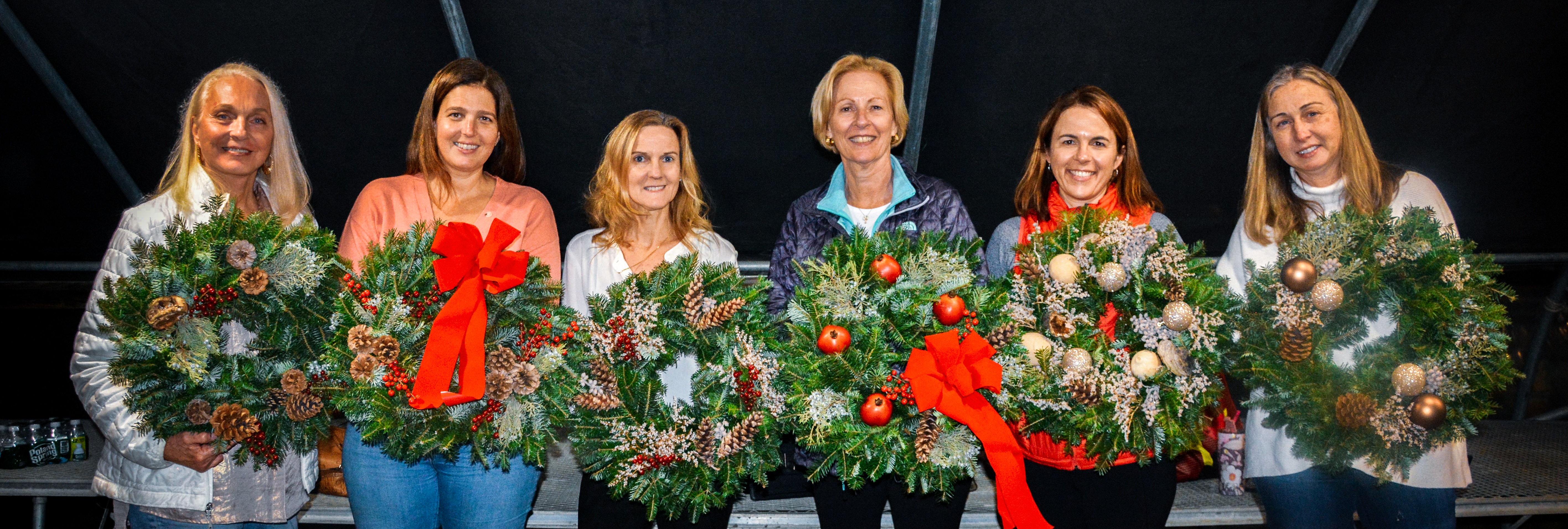 Previous year's attendees to our Wreath-Making class showing off their custom pieces to be displayed in their homes for the holiday season.